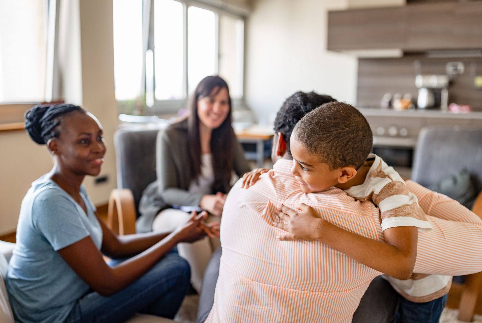 A Black family sits in a mental health professional's office