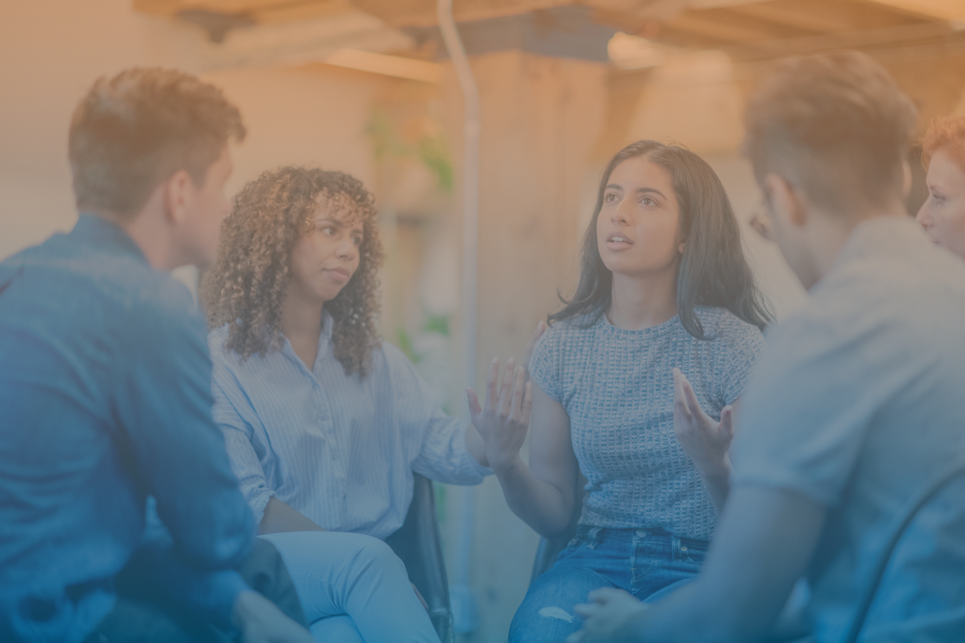 Four individuals talking while sitting in a circle
